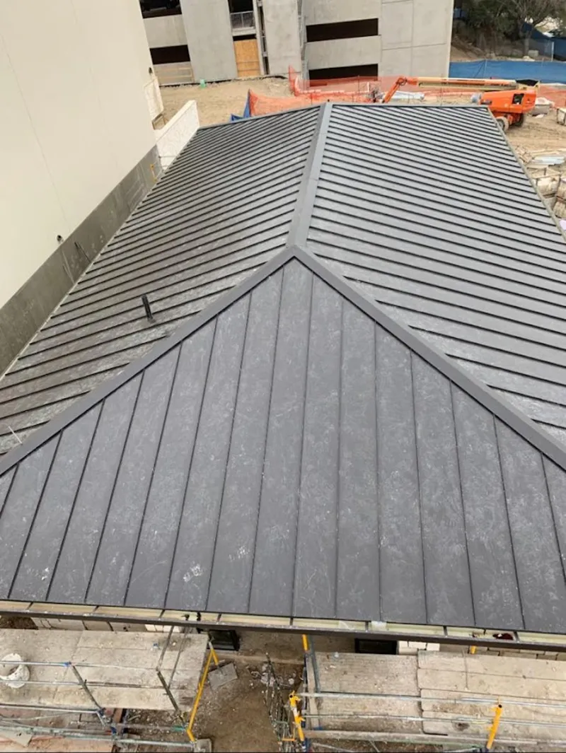 Commercial metal roof construction with crane equipment in Calumet City